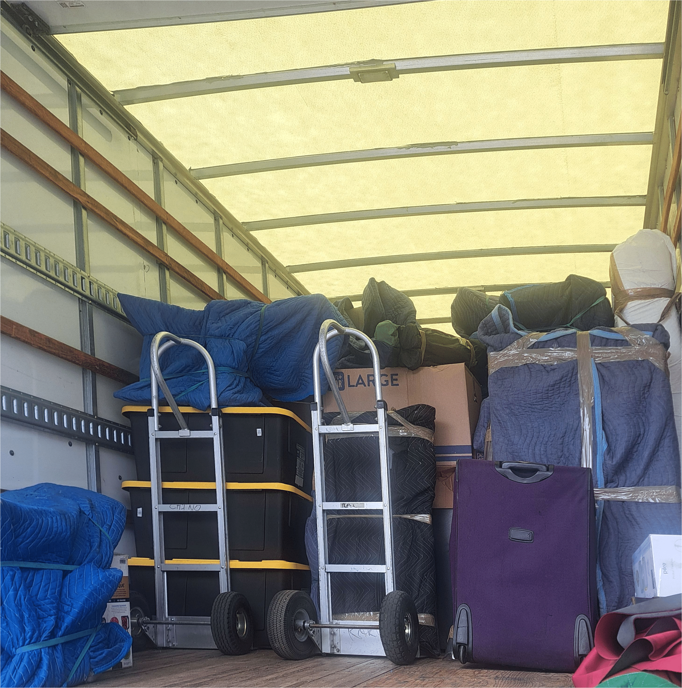 Professional moving dollies and straps used by Absolute Muscle Movers for safe transport
